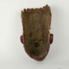 Holzmaske, 20. Jh., dunkelrot bemalt, beschädigt, Tragespuren. L: 36 cm.