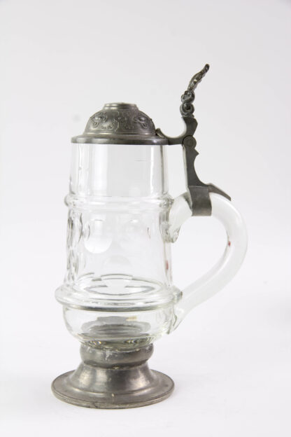 Bierkrug, um 1900, geschliffenes Glas, Zinndeckel, Fuß abgebrochen, und mit Zinnstand alt ergänzt, H: 24,5 cm. www.beyreuther.de