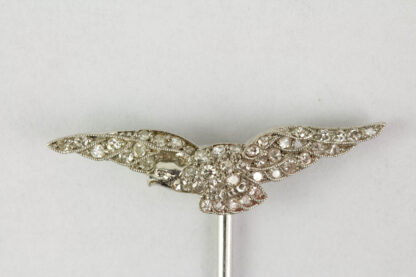 Krawattennadel, um 1900, 585er-Weißgold, in Form eines Adlers, mit Diamanten besetzt, feine Qualität. L: 4,9 cm, 1,8 g.